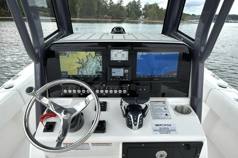 Slide: The Image of 2025 Sea Fox 282 Hybrid LT boat dashboard with advanced navigation displays and controls. - 8