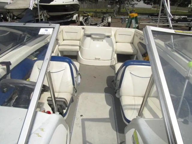 Slide: The Image of 2007 Bayliner 195 Discovery boat interior with seating and steering wheel. - 12