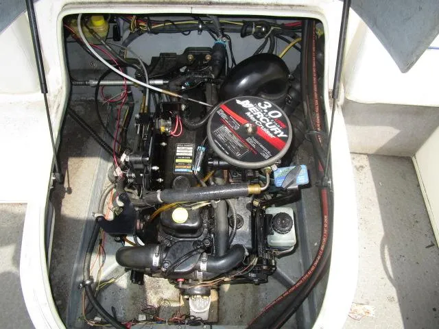 Slide: The Image of Engine compartment of a 2007 Bayliner 195 Discovery boat, featuring a 3.0 MerCruiser engine. - 13
