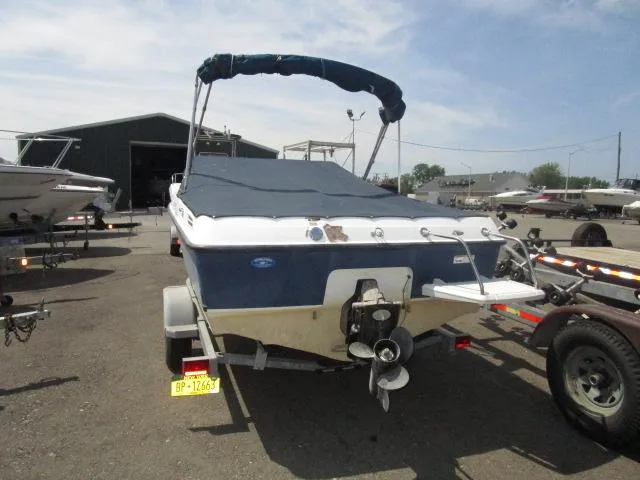 Slide: The Image of 2007 Bayliner 195 Discovery boat on trailer, covered and parked outdoors. - 3