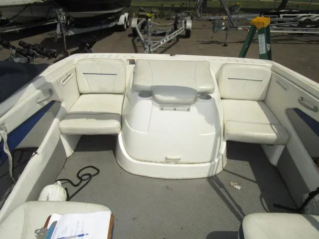 Slide: The Image of 2007 Bayliner 195 Discovery boat interior with white seating and storage compartments. - 5