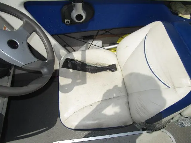 Slide: The Image of 2007 Bayliner 195 Discovery boat interior with worn seat and steering wheel. - 7