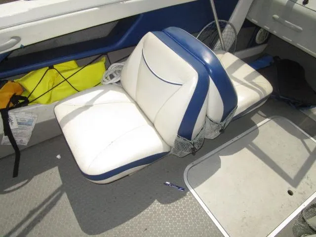 Slide: The Image of 2007 Bayliner 195 Discovery boat interior with white and blue seating. - 8