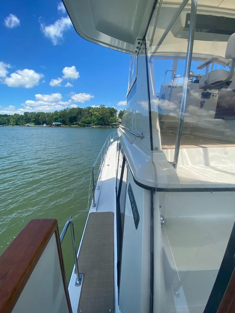 Slide: The Image of 1988 Carver 4207MY yacht on water, clear sky, side view, sunny day. - 4