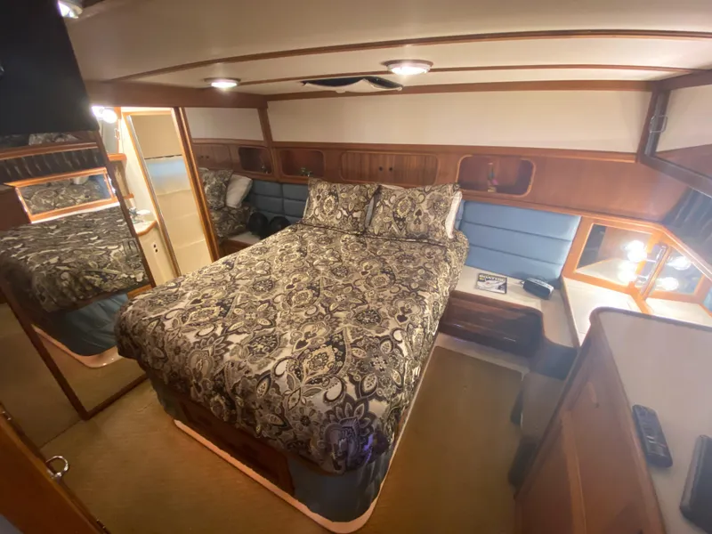 Slide: The Image of 1988 Carver 4207MY yacht bedroom with patterned bedding and wooden interior. - 15