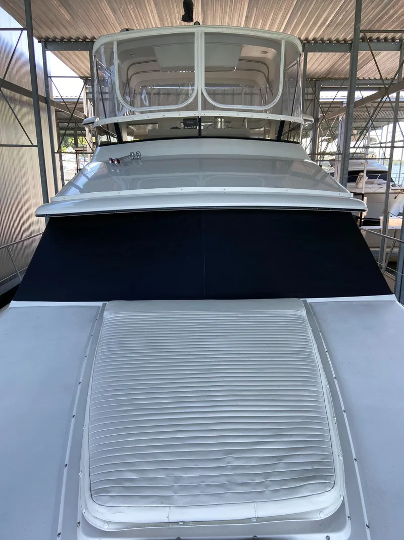 Slide: The Image of 1988 Carver 4207MY yacht under covered dock, front view. - 16