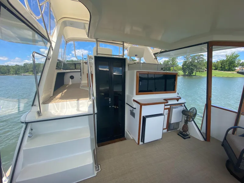 Slide: The Image of 1988 Carver 4207MY yacht interior with spacious deck and scenic lake view. - 5