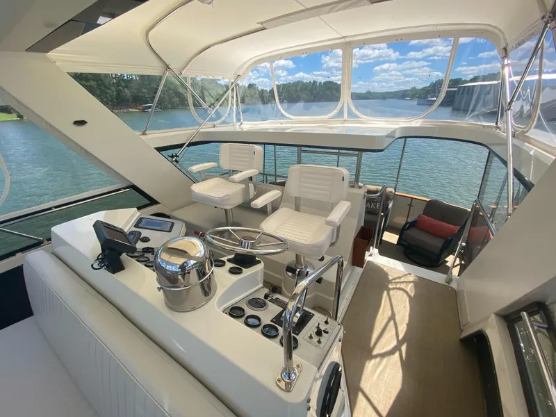 Slide: The Image of Interior view of 1988 Carver 4207MY yacht with helm and seating, overlooking water. - 8