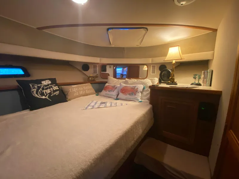 Slide: The Image of Cozy bedroom in 1988 Carver 4207MY yacht with plush bedding and ambient lighting. - 9