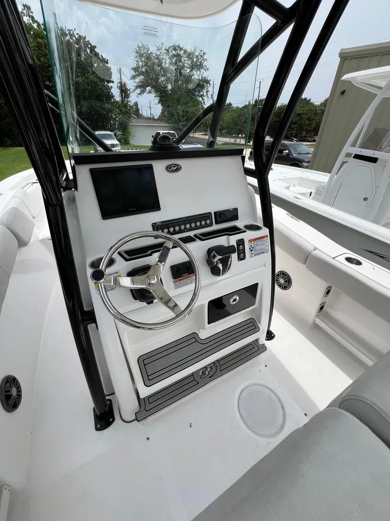 Slide: The Image of 2022 Sea Fox 248 Commander boat interior with cushioned seating and rod holders. - 10