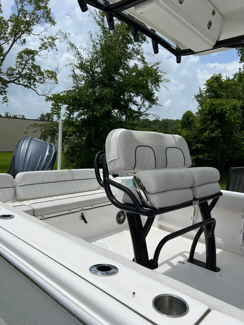 Slide: The Image of 2022 Sea Fox 248 Commander boat interior with white seating and deck, parked outdoors. - 11