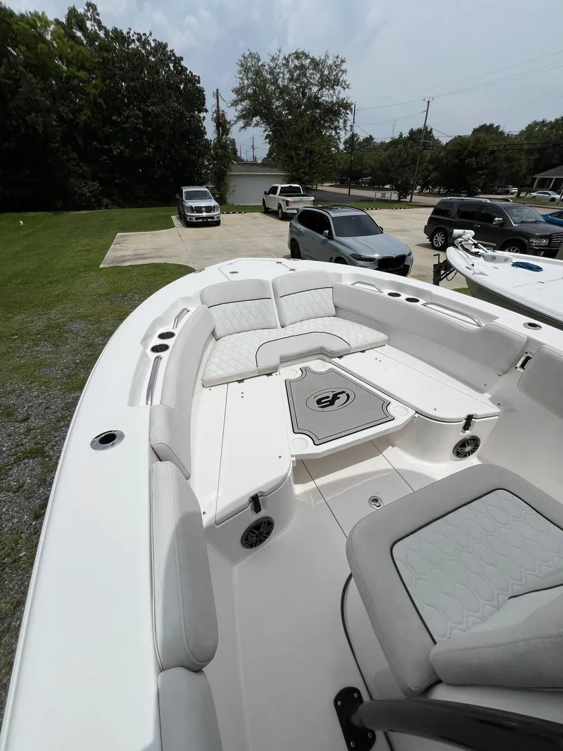 Slide: The Image of 2022 Sea Fox 248 Commander boat interior with seating and console, docked outdoors. - 12