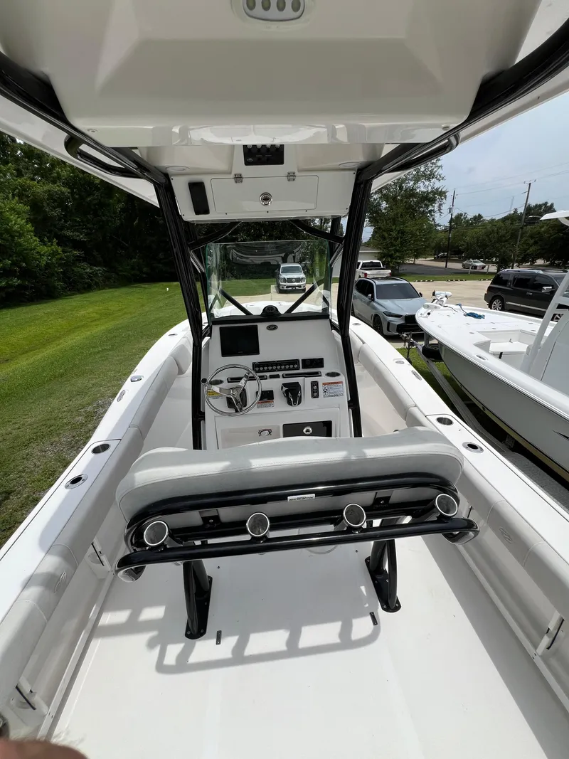 Slide: The Image of 2022 Sea Fox 248 Commander boat on trailer, parked on gravel and grass. - 18