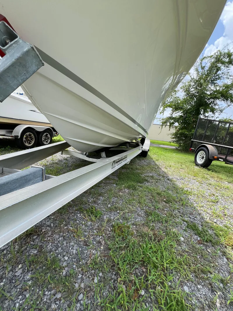 Slide: The Image of 2022 Sea Fox 248 Commander boat on trailer, parked on grassy area. - 19