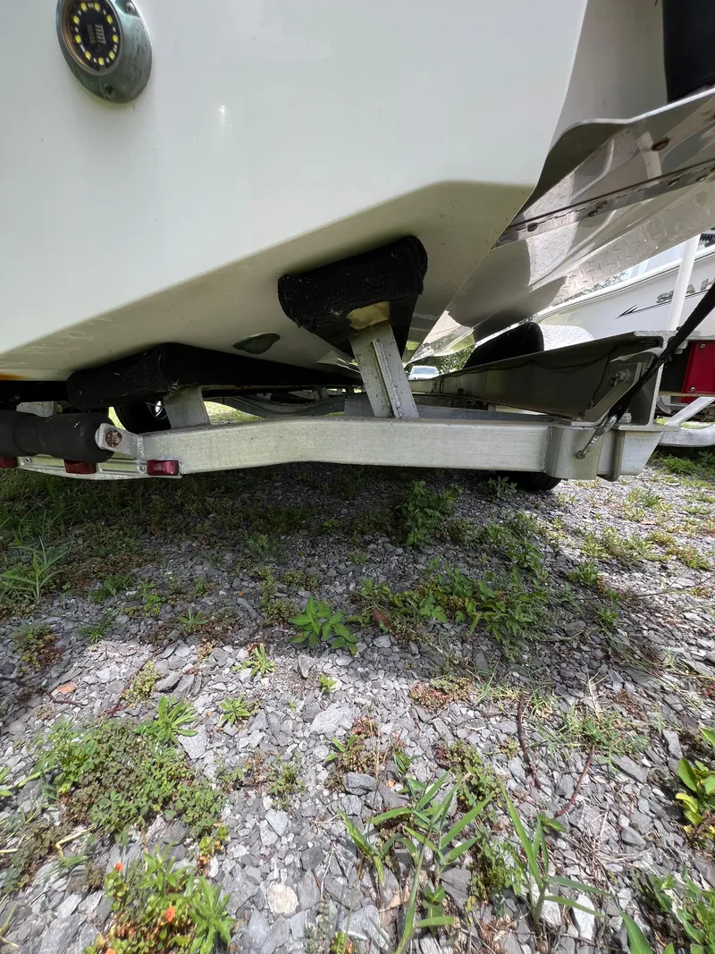 Slide: The Image of 2022 Sea Fox 248 Commander boat on trailer, grassy background, rear view. - 23