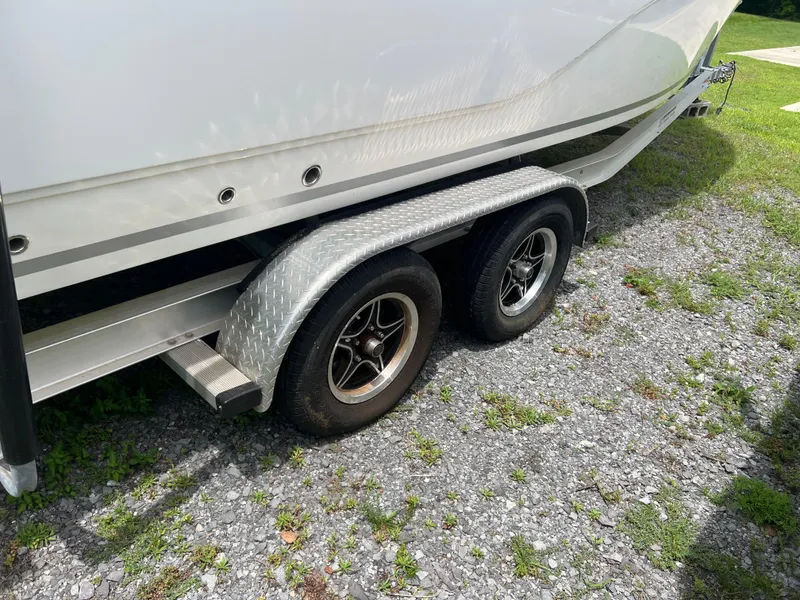 Slide: The Image of Trailer wheels of a 2022 Sea Fox 248 Commander boat on grass. - 25