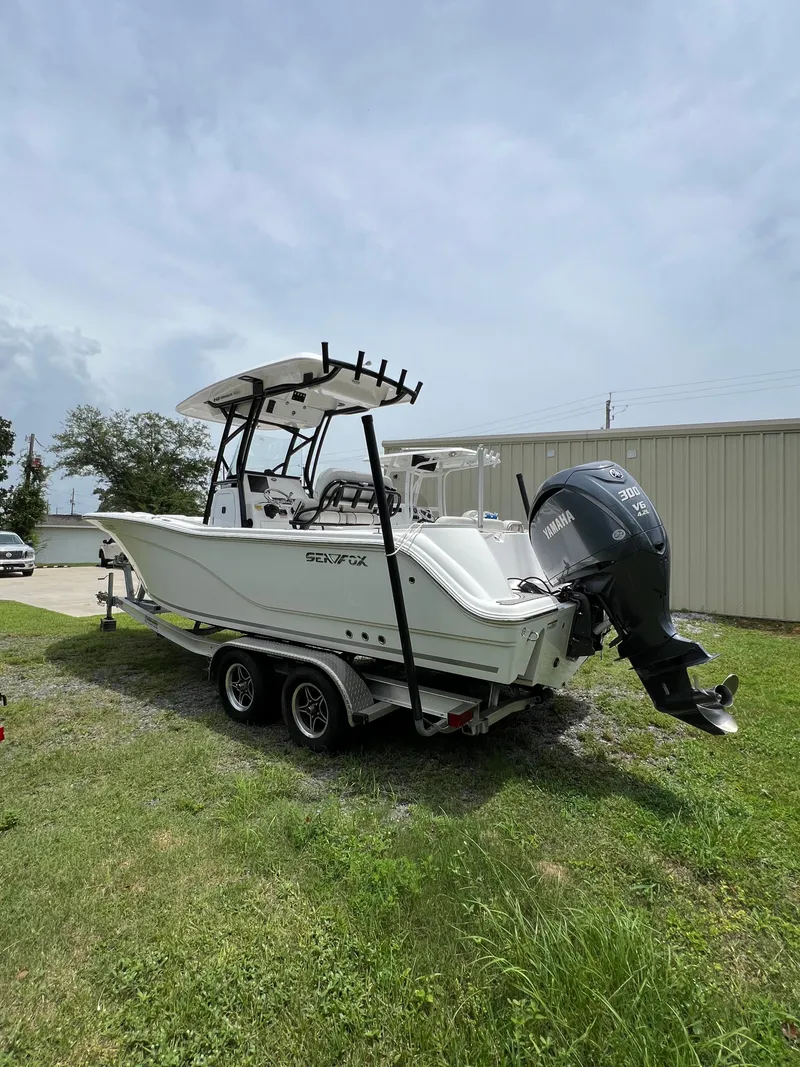 Slide: The Image of 2022 Sea Fox 248 Commander boat with Yamaha V6 engine, parked on grass. - 5