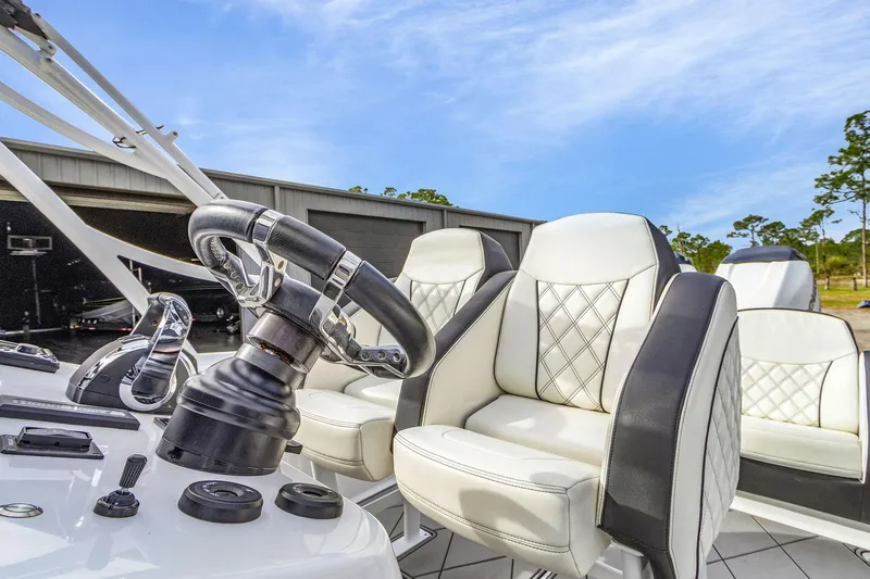 Slide: The Image of 2020 Renegade 32' Cuddy boat interior with luxury seating and steering wheel. - 12