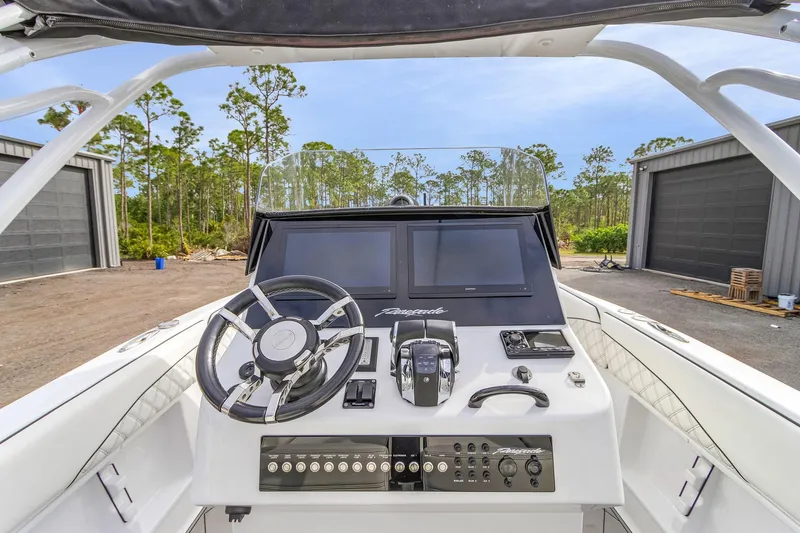 Slide: The Image of 2020 Renegade 32' Cuddy boat helm with modern controls and dual screens. - 14