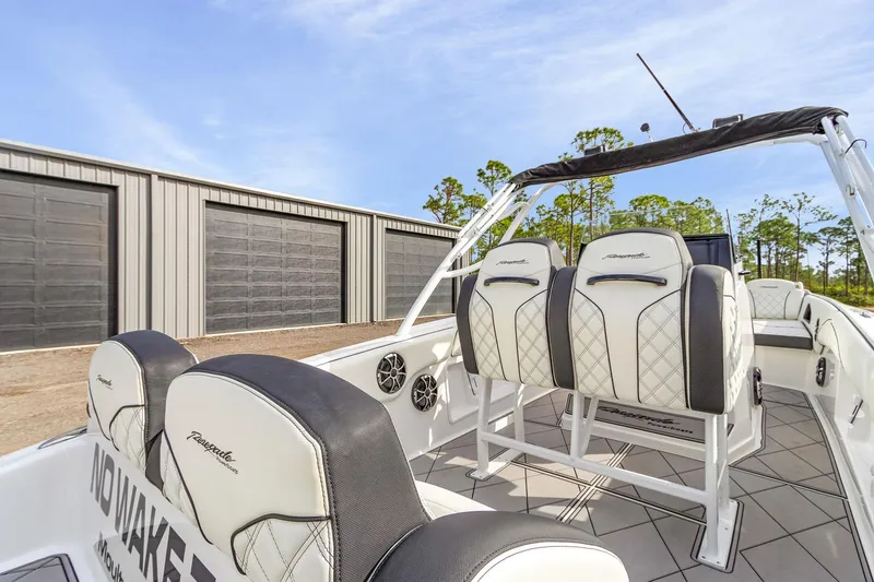 Slide: The Image of 2020 Renegade 32' Cuddy boat interior with white seating and storage units in background. - 16