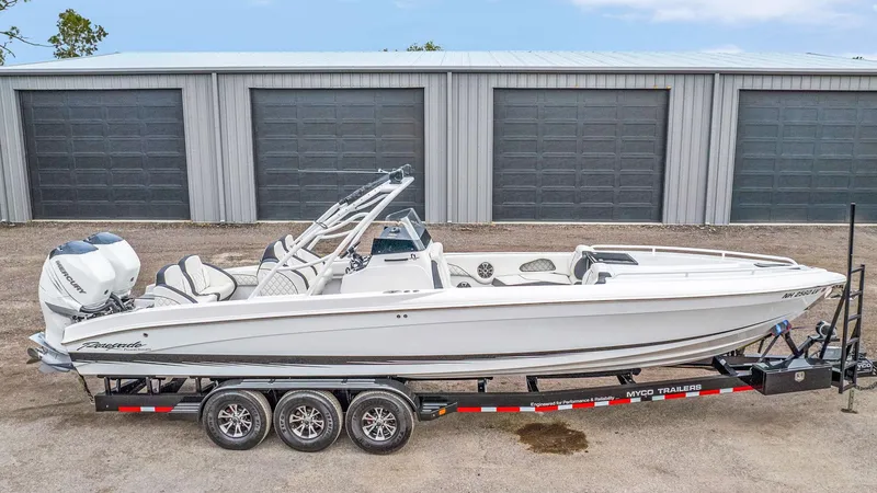 Slide: The Image of 2020 Renegade 32' Cuddy boat on trailer, parked in front of storage units. - 21