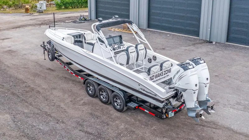 Slide: The Image of 2020 Renegade 32' Cuddy boat on trailer, featuring dual Mercury engines. - 24