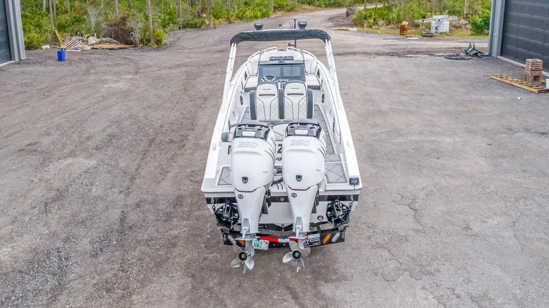 Slide: The Image of 2020 Renegade 32' Cuddy boat with twin 350 engines, parked outdoors. - 25