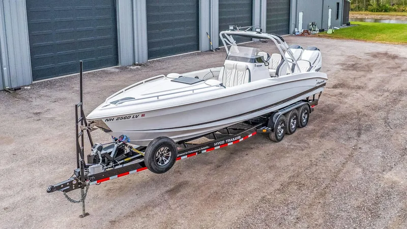 Slide: The Image of 2020 Renegade 32' Cuddy boat on trailer, parked outside industrial building. - 27