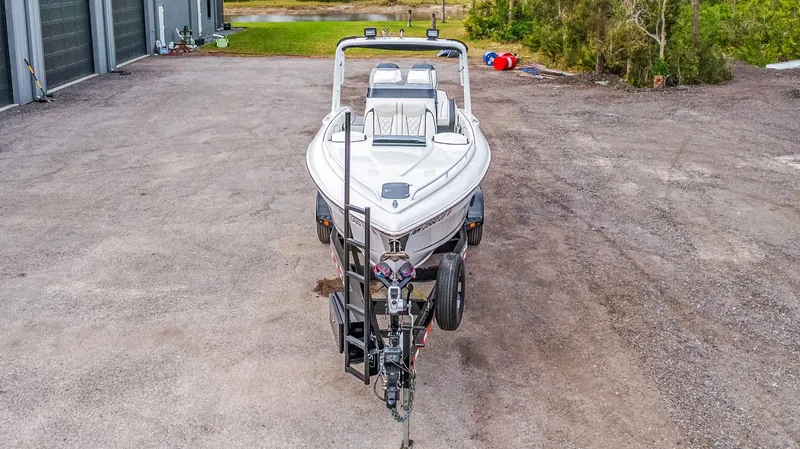 Slide: The Image of 2020 Renegade 32' Cuddy boat on trailer in outdoor setting. - 28