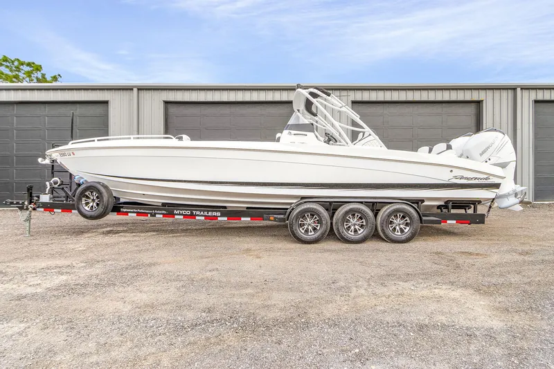 Slide: The Image of 2020 Renegade 32' Cuddy boat on trailer, parked outside garage. - 4
