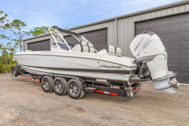 Slide: The Image of 2020 Renegade 32' Cuddy boat on trailer, parked near a garage. - 6