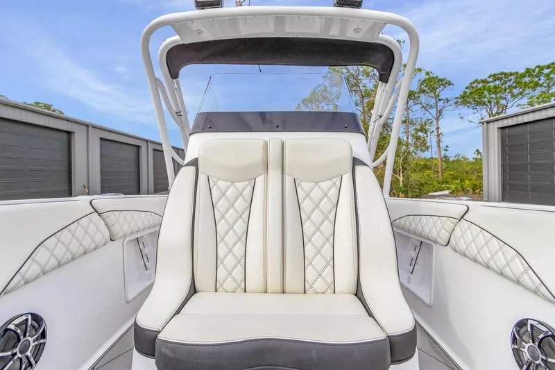 Slide: The Image of 2020 Renegade 32' Cuddy boat interior with luxurious white seating and modern design. - 9