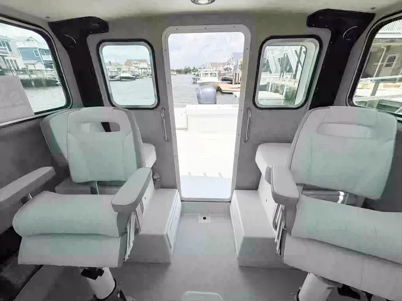 Slide: The Image of 2021 Parker 2520 XLD Sport Cabin interior with two seats and waterfront view. - 13