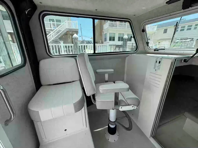 Slide: The Image of Interior of 2021 Parker 2520 XLD Sport Cabin with seating and windows. - 14
