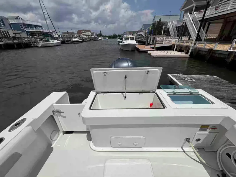 Slide: The Image of 2021 Parker 2520 XLD Sport Cabin boat docked in a scenic marina. - 17