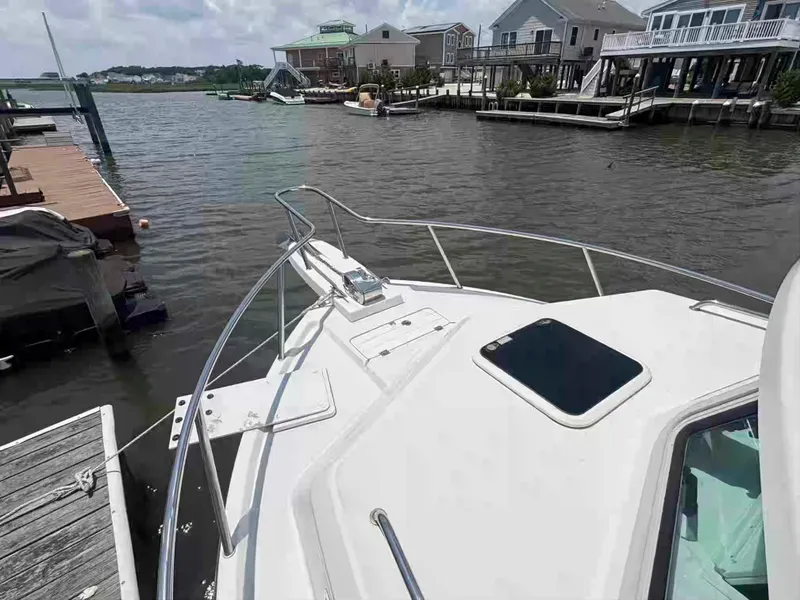 Slide: The Image of 2021 Parker 2520 XLD Sport Cabin docked near waterfront homes. - 18