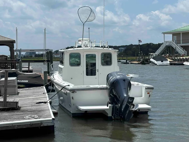 Slide: The Image of 2021 Parker 2520 XLD Sport Cabin boat docked at marina, rear view. - 3