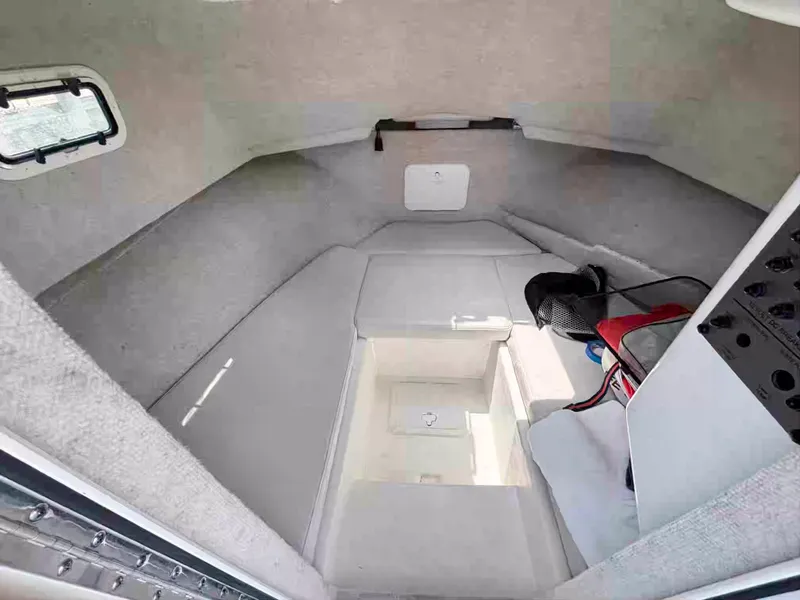 Slide: The Image of Interior cabin of 2021 Parker 2520 XLD Sport Cabin boat, featuring seating and storage. - 8