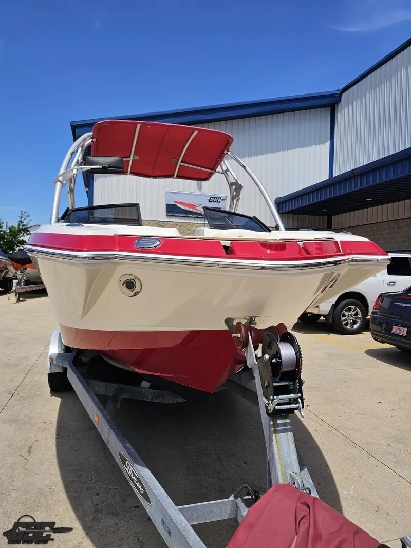 Slide: The Image of 2008 Chaparral Sunesta 224 boat on trailer, red and white, parked outdoors. - 10