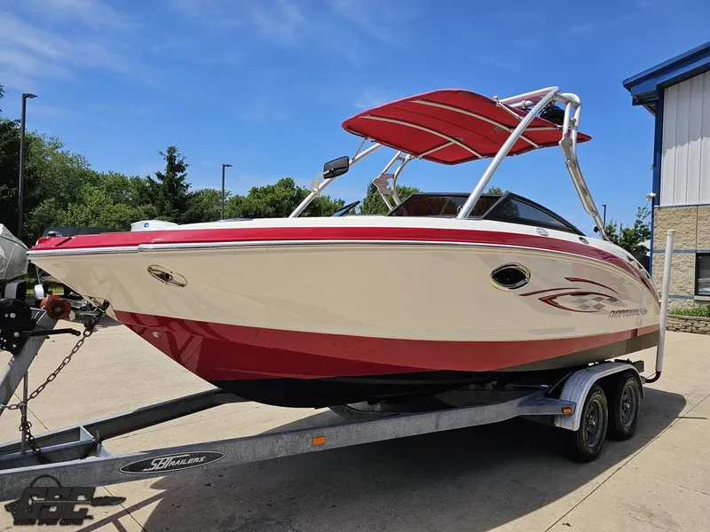Slide: The Image of 2008 Chaparral Sunesta 224 boat on trailer, red and white design, parked outdoors. - 14
