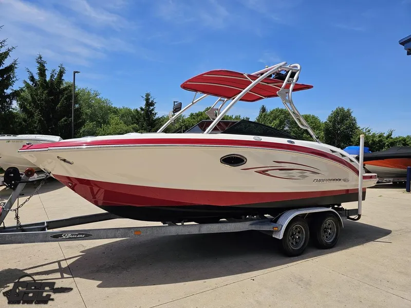 Slide: The Image of 2008 Chaparral Sunesta 224 boat on trailer, red and white design, parked outdoors. - 15