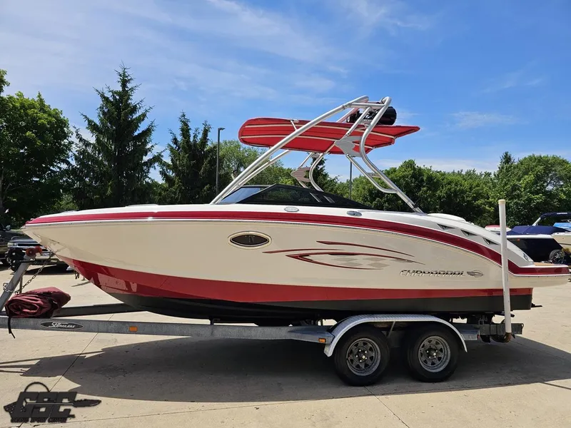 Slide: The Image of 2008 Chaparral Sunesta 224 boat on trailer, red and white design, parked outdoors. - 16