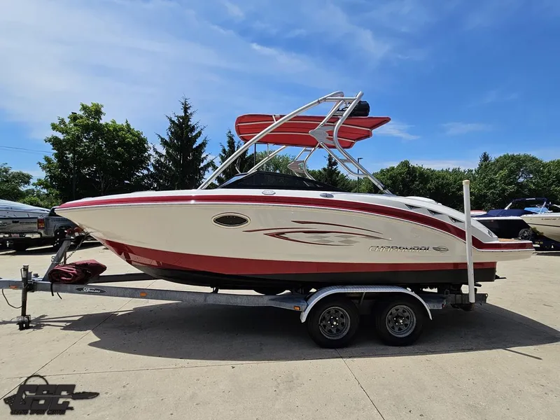 Slide: The Image of 2008 Chaparral Sunesta 224 boat on trailer, red and white design, parked outdoors. - 17