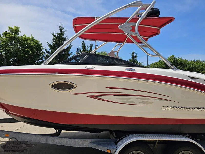 Slide: The Image of 2008 Chaparral Sunesta 224 boat with red accents on a trailer, outdoors. - 18