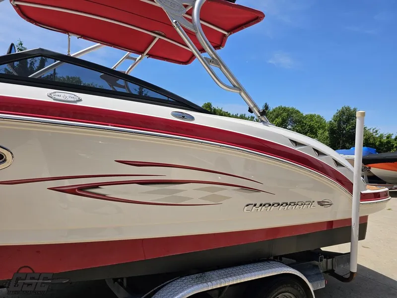 Slide: The Image of 2008 Chaparral Sunesta 224 boat with red accents and canopy on a trailer. - 20