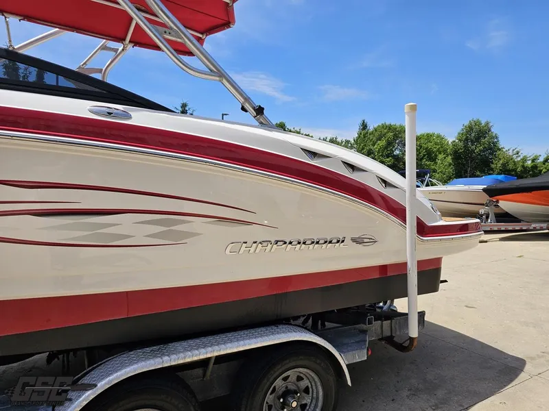 Slide: The Image of 2008 Chaparral Sunesta 224 boat on trailer, red and white design, sunny day. - 21
