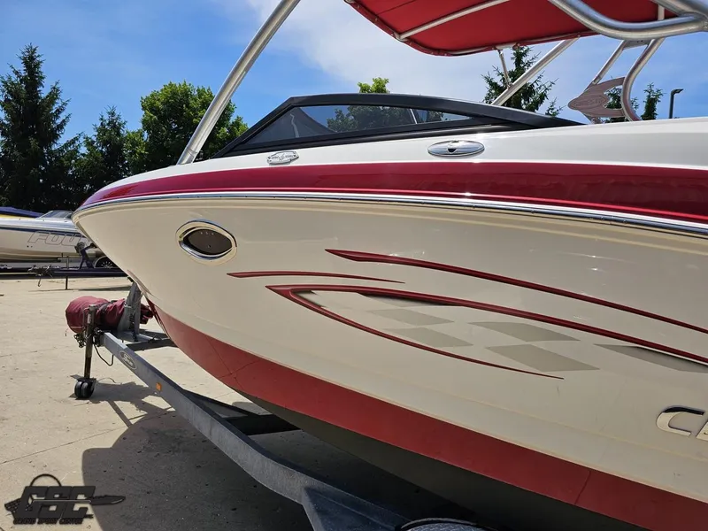 Slide: The Image of 2008 Chaparral Sunesta 224 boat with red and white design on a trailer. - 22