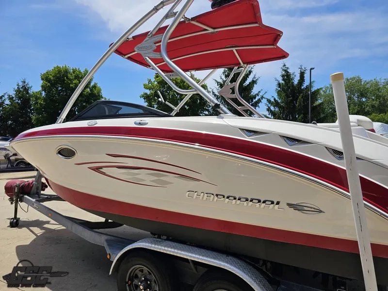 Slide: The Image of 2008 Chaparral Sunesta 224 boat on trailer, red and white design, sunny day. - 24