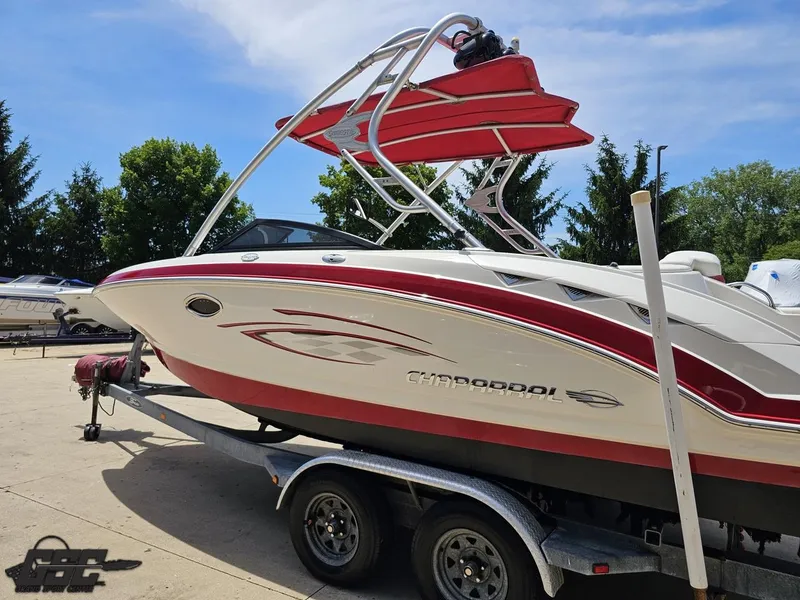Slide: The Image of 2008 Chaparral Sunesta 224 boat on trailer, red and white design, sunny day. - 25