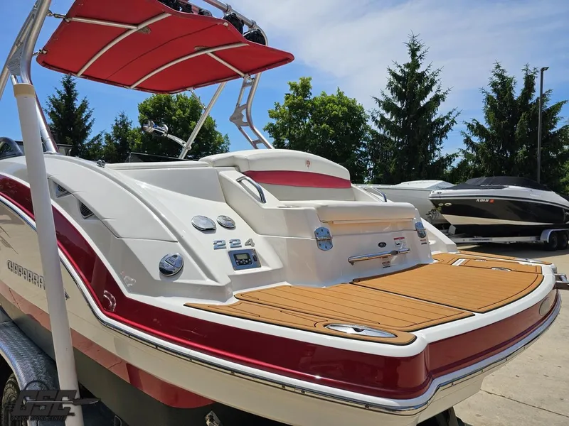 Slide: The Image of 2008 Chaparral Sunesta 224 boat with red accents and swim platform, parked outdoors. - 26